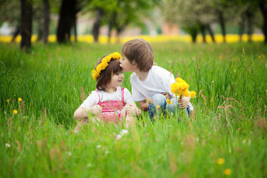 Children kissing in meadow