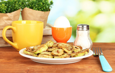 Fried zucchini with eggs and coffee for breakfast