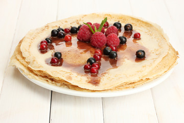 Delicious pancakes with berries and chocolate