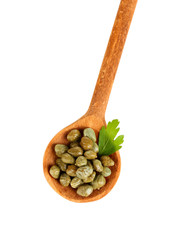 green capers in wooden spoon on white background close-up