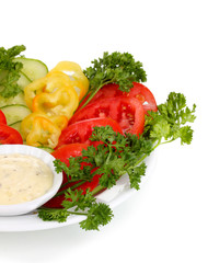 Chopped vegetables and sauce on plate isolated on white