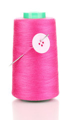Pink bobbin with needle and buttons isolated on white