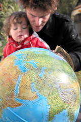 Father and son with a globe