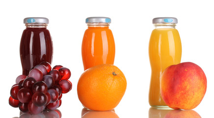 Delicious grapes, orange and apple juice in glass bottle and