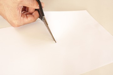 scissors cutting white paper