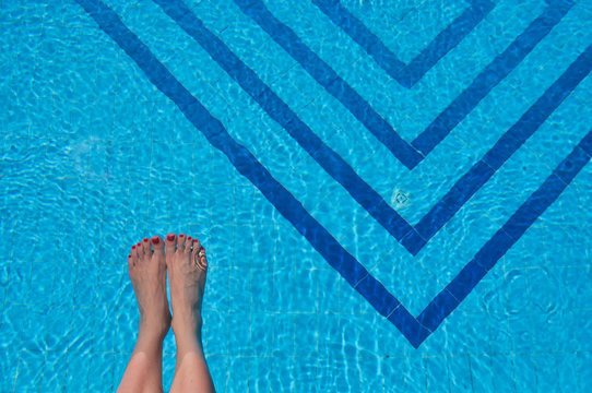 Woman's feet in a swimming pool