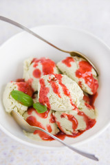Yogurt avocado ice cream with strawberry sauce