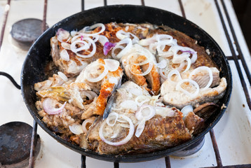 Fried fish in a frying pan