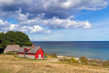 Fototapeta na wymiar Traditional red Swedish cottage house at Baltic Sea