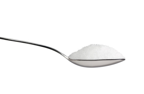 Salt or sugar on a teaspoon isolated on white background