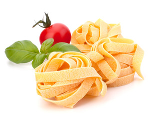 Fototapeta na wymiar Italian pasta fettuccine nest and cherry tomato