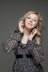 Fototapeta premium young blond female gently looking while her hair flying