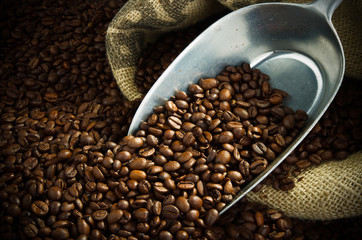 sack full of fresh coffee beans with a metal scoop