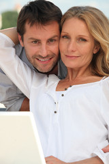 Couple with laptop in garden