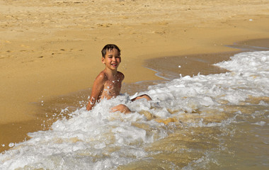 Boy playing in the waves