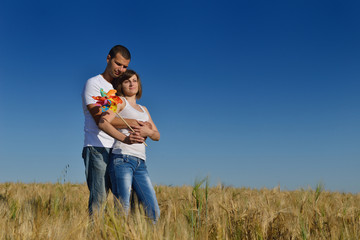 Naklejka na ściany i meble happy couple in wheat field