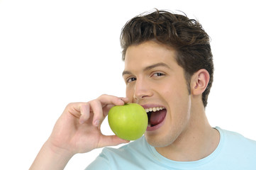 Young man eating green and healthy apple