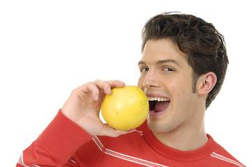 Young man eating grapefruit