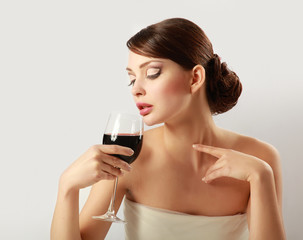 Beautiful brunet girl drinking red wine