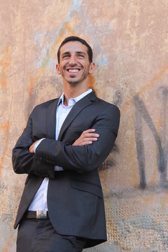 Middle-east businessman standing near a wall