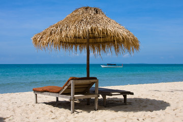 Sun loungers with umbrella on the beach
