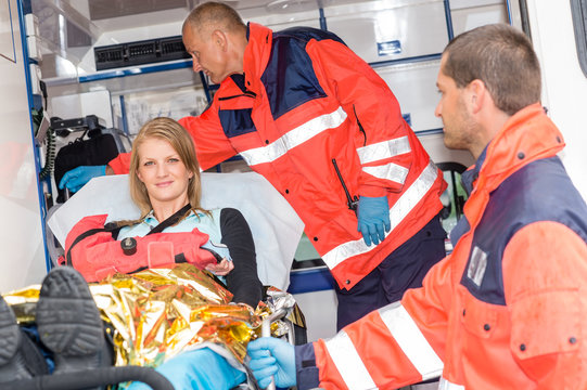 Woman with broken arm in ambulance paramedics