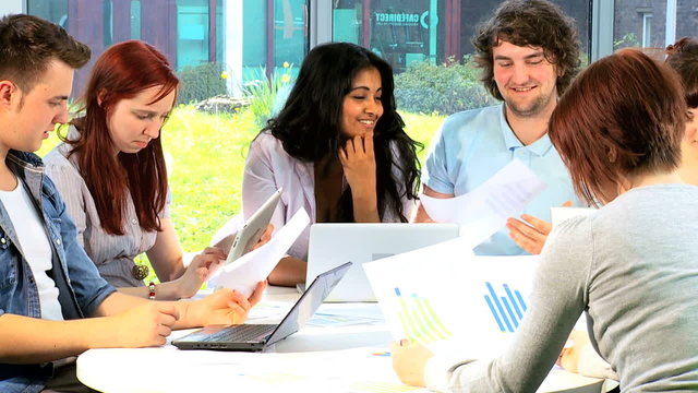 Diverse university colleagues learning with computers