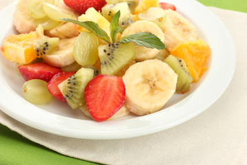 Fresh fruits salad on plate close up