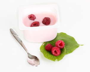 Yogurt with raspberry isolated on white