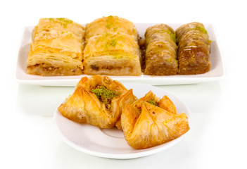 Sweet baklava on plates isolated on white
