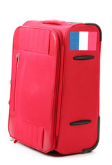 red suitcase with sticker with flag of France isolated on white