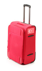 red suitcase with sticker with flag of Turkey isolated on white
