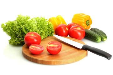 fresh vegetables and knife on cutting board isolated on white