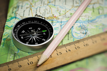 Compass, ruler and pencil on a road map
