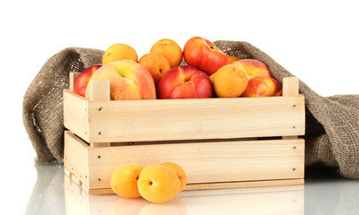 Ripe fruit in wooden box on white background close-up
