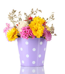 Purple bucket with white polka-dot with flowers isolated