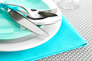 blue empty plates with fork, spoon and knife