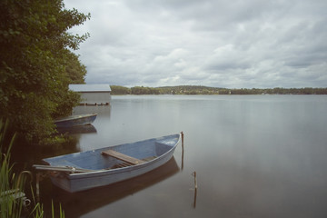 boats moored on lake, long exposure