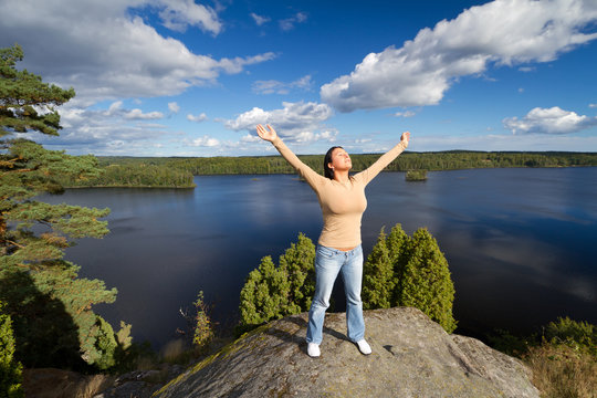 Young brunette at meditation in idyllic scenery of Sweden