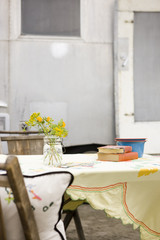 woman sitting at a table on the beach outside her airstream classic trailer
