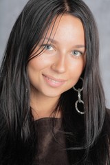 Portrait of beautiful female model on gray background