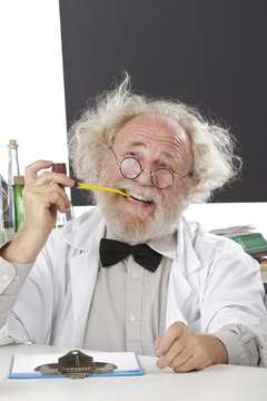 Eccentic scientist in lab thinks of ideas