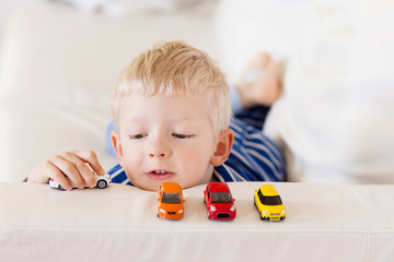 toddler plays toy cars