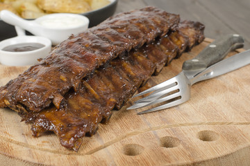 BBQ Ribs - Pork ribs & potato wedges. BBQ sauce & sour cream