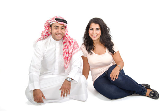 Arab Couple Sitting On The Floor On White Back Ground