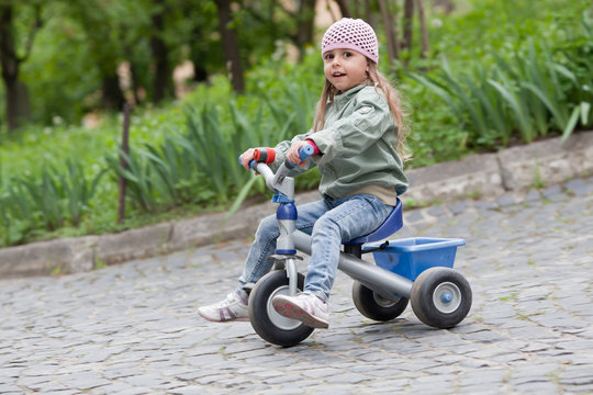 Little girl ( 4-5) on tricycle