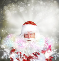 Christmas theme: Santa Claus blowing snowflakes from his arms. D