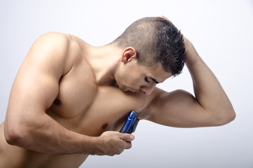 Naklejka premium young man shaving the armpit,