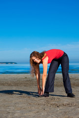 girl doing morning exercises at the beach
