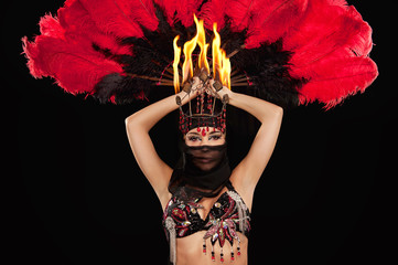 Belly dancer with feather fan wearing a hijab & fire headdress